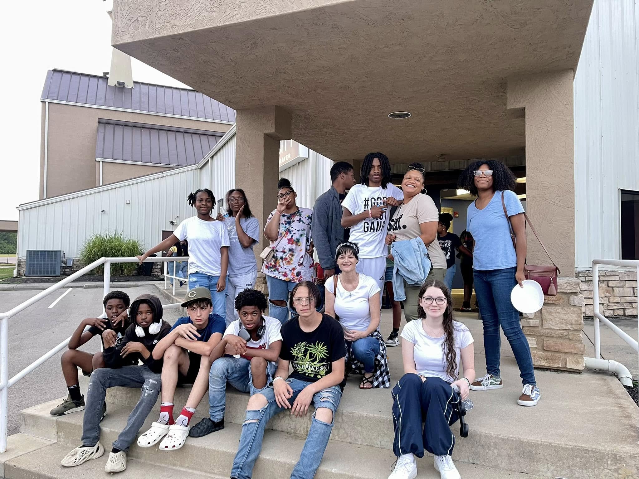 Young adults and youth gathered outside during a Columbus outreach event