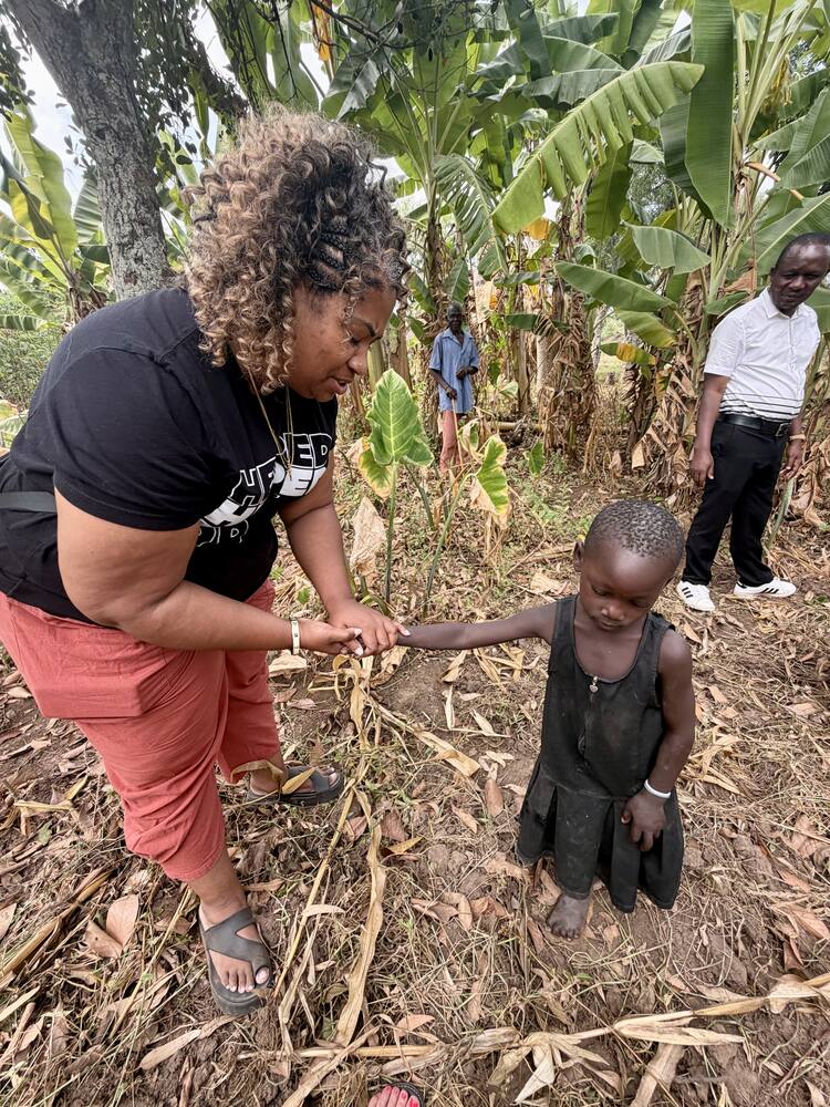 Oasis ministry leader praying with a child in East Africa