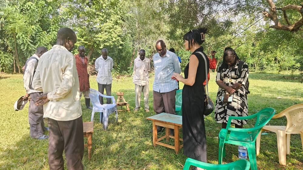 Prayer gathering outdoors with ministry leaders in East Africa